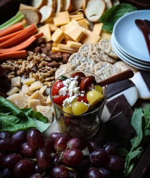 A cheese board with sweet and savory foods